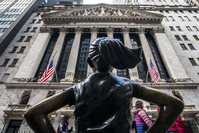 People walk around the New York Stock Exchange in New York, Tuesday, March 19, 2024. U.S. stocks are rising Tuesday as Wall Street waits to hear what the Federal Reserve will do with interest rates.