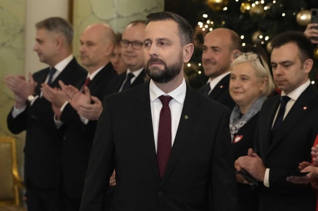 FILE - Wladyslaw Kosiniak-Kamysz deputy Prime Minister and Defence Minister, centre, attends the swearing-in ceremony at the presidential palace in Warsaw, Poland, on Dec. 13, 2023. Poland’s government has readied legislation to enhance public security at times of threat or danger by activating citizens self-defense potential, officials said Friday March 22, 2024.