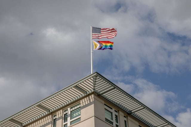 A symbol of unity and inclusiveness adorns the front of the US Embassy in Berlin on June 28, 2023. In a tribute to the historic Stonewall uprising, which occurred 54 years ago at New York City's renowned Stonewall Inn on Christopher Street, the American flag intertwines with the Progress Pride flag, demonstrating support for the LGBTQI+ community. As these flags are proudly raised above the German capital by the United States Embassy, it serves as a poignant reminder of the ongoing global fight for equality and acceptance.