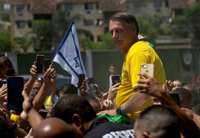 Brazil’s former president Jair Bolsonaro is surrounded by supporters after attending a campaign event in Rio de Janeiro, Brazil on March 16. Photo: AP