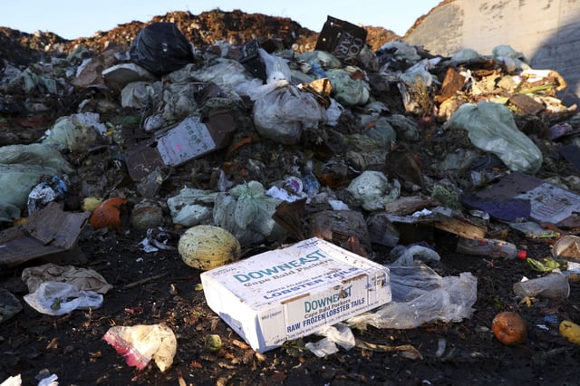 A box of frozen lobster tails is discarded with other food scraps in San Francisco, US, in 2022.