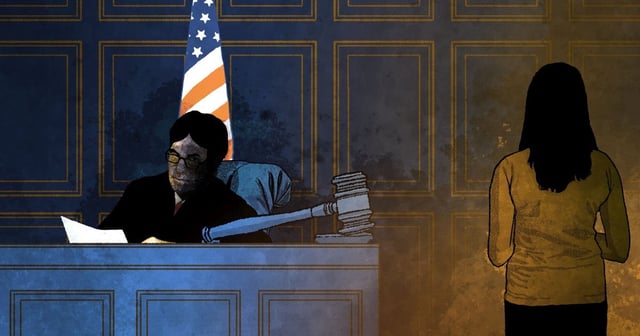 A girl stands in front of a judge in a courtroom
