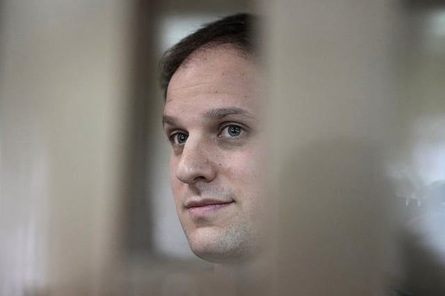 Evan Gershkovich stands at the Moscow City Court in Moscow, on Oct. 10, 2023.