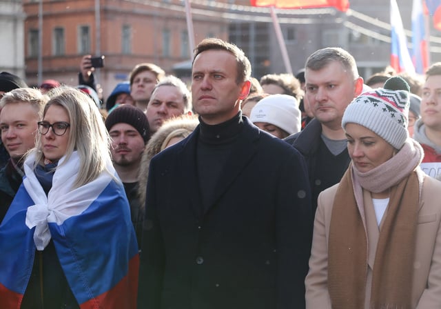 In this February 2020 photo, Alexey Navalny and his wife Yulia walk with demonstrators during a rally in Moscow, Russia.