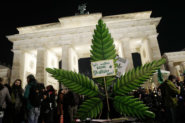 Cannabis enthusiasts smoke joints legally at the Brandenburg Gate at shortly after midnight on April 1, 2024 in Berlin, Germany. Germany's new cannabis law goes into effect today, bringing in a new era of legal cannabis consumption. Cannabis social clubs will also be allowed to grow their own marijuana beginning later this year.