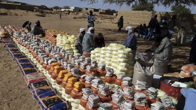This handout photo provided by World Relief shows emergency food being distributed by World Food Programme (WFP) and World Relief in Kulbus, West Darfur, Sudan, end of March 2024. The United Nations said Friday, April 5, 2024, it has begun distributing food in Sudan’s war-ravaged Darfur province for the first time in months, following two successful cross-border operations, but the population still faces widespread starvation unless more help arrives. (World Relief via AP)