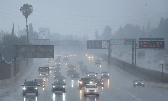 FILE - Commuters drive under heavy rainfall in Los Angeles on March 21, 2018.