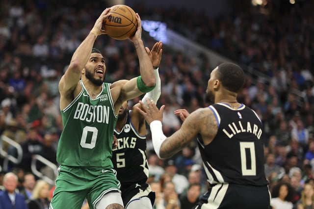 MILWAUKEE, WISCONSIN - APRIL 09: Jayson Tatum #0 of the Boston Celtics drives to the basket against Damian Lillard #0 of the Milwaukee Bucks during the second half of a game at Fiserv Forum on April 09, 2024 in Milwaukee, Wisconsin. NOTE TO USER: User expressly acknowledges and agrees that, by downloading and or using this photograph, User is consenting to the terms and conditions of the Getty Images License Agreement. (Photo by Stacy Revere/Getty Images)