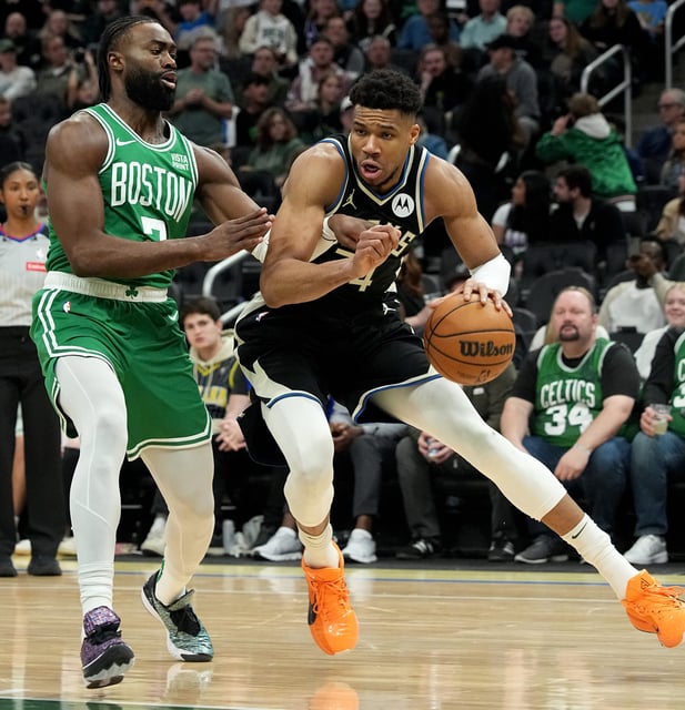 Boston Celtics guard Jaylen Brown (7) guards Milwaukee Bucks forward Giannis Antetokounmpo (34) in the third quarter on Tuesday night. Antetokounmpo left the game later with a left soleus strain.