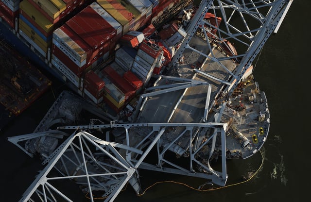 BALTIMORE, MARYLAND - APRIL 09:  In an aerial view, salvage crews continue to remove wreckage from the cargo ship Dali after it stuck and collapsed the Francis Scott Key Bridge, April 09, 2024 in Baltimore, Maryland. The Unified Command has started removing containers from the Dali while also working to clear the channel to restore the flow of commerce to the Port of Baltimore. The bridge collapsed after being struck by the 984-foot cargo ship Dali at 1:30 AM on March 26. (Photo by Kevin Dietsch/Getty Images)