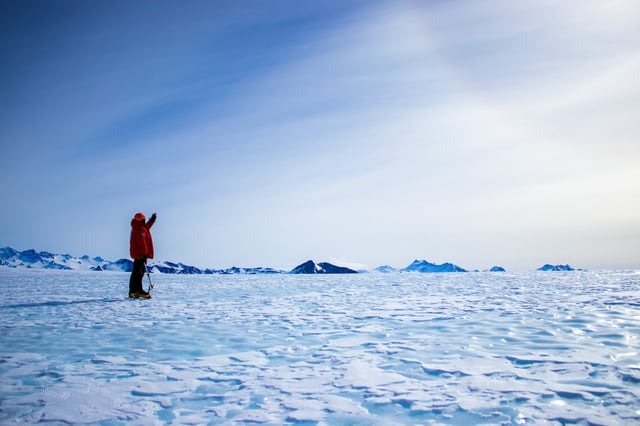 Field guide in a blue ice area during a mission to take ice samples. Photo taken during the 2023-2024 fieldwork mission of the Instituto Antártico Chileno (INACH) to Union Glacier, Ellsworth Mountains, Antarctica. Credit: Veronica Tollenaar, Université libre de Bruxelles