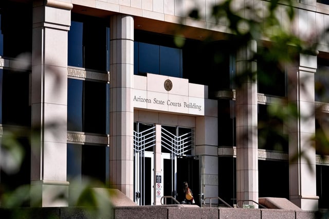 A woman enters the Arizona Supreme Court building, in Phoenix, on April 10, 2024.