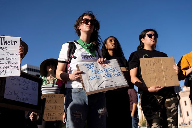 Protesters take part in a rally in Tucson, Arizona, on Tuesday after the state Supreme Court revived a law dating to 1864 that bans abortion in virtually all instances.
