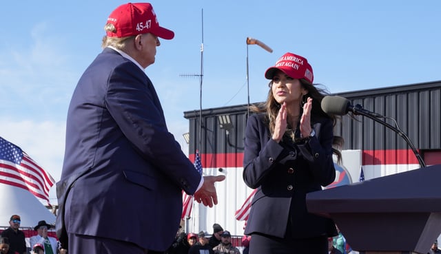 Republican presidential candidate and former President Donald Trump, left, shakes hands with South Dakota Gov. Kristi Noem at a campaign rally Saturday, March 16, 2024, in Vandalia, Ohio. (AP Photo/Jeff Dean)