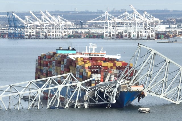 Francis Scott Key Bridge sits on top of a container ship after the bridge collapsed in Baltimore, on March 26, 2024.
