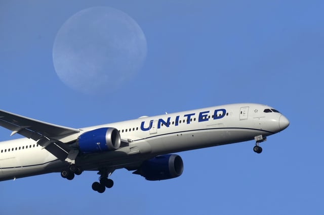 A United Airlines Boeing 787 approaches for landing in Lisbon, Sept. 2, 2023, with the setting moon in the background. United Airlines reports their earnings on Tuesday, april 16, 2024. (AP Photo/Armando Franca, File)