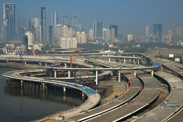Laborers work on a portion of the Coastal Road expressway along Mumbai's coastline.