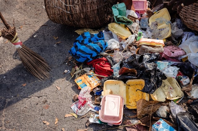 Lagos State Waste Management Authority (LAWMA) staff cleans up piled up waste from the road side at Ikoyi in Lagos on January 2024