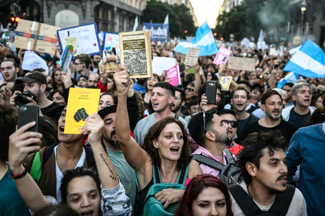 Demonstrators sing the national anthem during a march in protest of the budget adjustment to public universities in Buenos Aires on April 23, 2024.