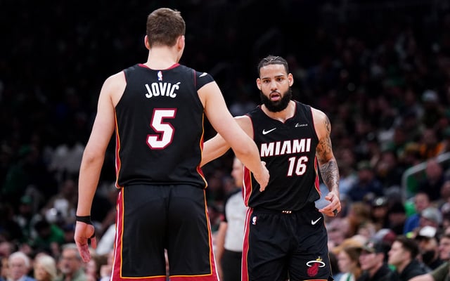 Apr 24, 2024; Boston, Massachusetts, USA; Miami Heat forward Caleb Martin (16) is congratulated after his three point basket by forward Nikola Jovic (5) against the Boston Celtics in the second quarter during game two of the first round for the 2024 NBA playoffs at TD Garden. Mandatory Credit: David Butler II-USA TODAY Sports