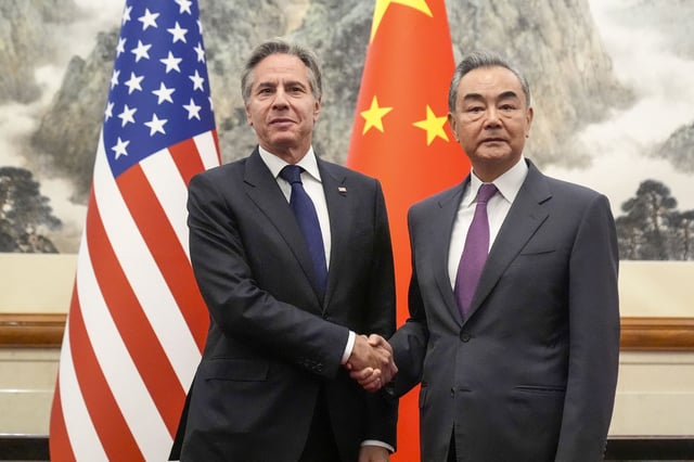 US Secretary of State Antony Blinken shakes hands with China's Foreign Minister Wang Yi during a meeting at the Diaoyutai State Guesthouse in Beijing on April 26.