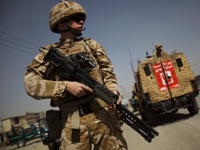 KABUL, AFGHANISTAN - AUGUST 18: British soldiers and the Afghan National Police secure the site of a suicide bomb blast on August 18, 2009 in Kabul, Afghanistan. Seven people were killed and over 50 wounded after a suicide car bomber attacked a convoy of foreign troops. The attack took place on a major artery leading out of Kabul, just two days ahead of the Presidential elections. (Photo by Daniel Berehulak/Getty Images)