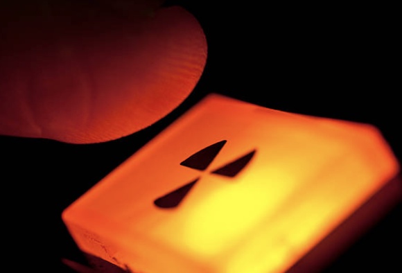 Finger hovering over an illuminated radiation warning sign - or the nuclear option (...or a piece of laboratory equipment actually). Getty Images/David Hills)