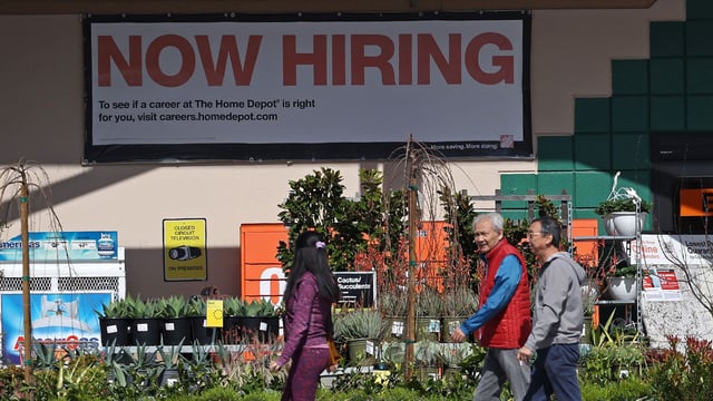 Home Depot customers walk by a posted now hiring sign on March 08, 2024, in San Rafael, California.