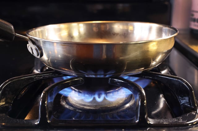 CHICAGO, ILLINOIS - JANUARY 12: In this photo illustration, a pan sits on flames burning on a natural gas-burning stove on January 12, 2023 in Chicago, Illinois. Consumers and politicians have voiced concern after the commissioner of the Consumer Product Safety Commission (CPSC) recently suggested that gas stoves were a health hazard, leading people to believe that they would be banned. (Photo Illustration by Scott Olson/Getty Images)