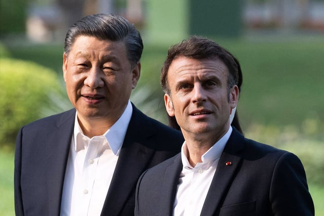 Chinese President Xi Jinping and French President Emmanuel Macron visit a garden in Guangdong during Macron's state visit to China last April.