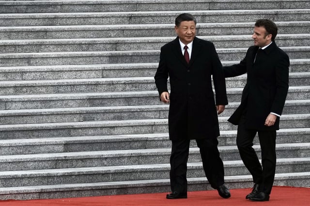 Chinese President Xi Jinping, left, and France's President Emmanuel Macron attend a welcome ceremony, at the Great Hall of the People in Beijing, China, on April 6, 2023. French President Emmanuel Macron will seek to press China's Xi Jinping to use his influence to move Russia toward ending the war in Ukraine during a two-day state visit to France. Both leaders were also expected to discuss trade disputes over electric cars, cognac and cosmetics. (AP Photo/Thibault Camus, File)