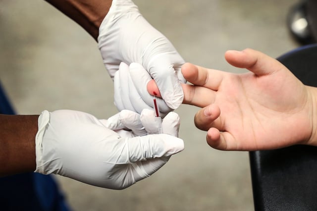 A medical assistant draws blood from a patient on National HIV Testing Day at a Planned Parenthood health center on June 27, 2017 in Miami.