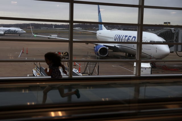 A young passenger runs through a hallway at Ronald Reagan Washington National Airport in Arlington, Virginia on November 21, 2023.