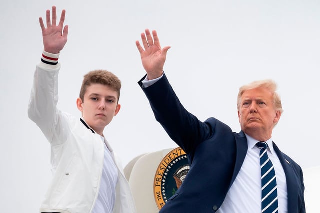 US President Donald Trump and his son Barron wave as they board Air Force One at Morristown Municipal Airport in Morristown, New Jersey, on August 16, 2020.