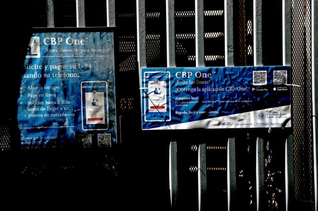 MEXICALI, BAJA CALIFORNIA - MAY 13: Signs annoucing the CPB One mobile application at the port of entry along the U.S.-Mexico border on Saturday, May 13, 2023 in Mexicali, Baja California. Title 42, a pandemic-era policy that allowed border agents to quickly turn back migrants, expires this week. Under a new rule, the U.S. on Thursday will begin denying asylum to migrants who show up at the U.S.-Mexico border without first applying online using the CBP One mobile application or seeking protection in a country they passed through. (Gary Coronado / Los Angeles Times via Getty Images)