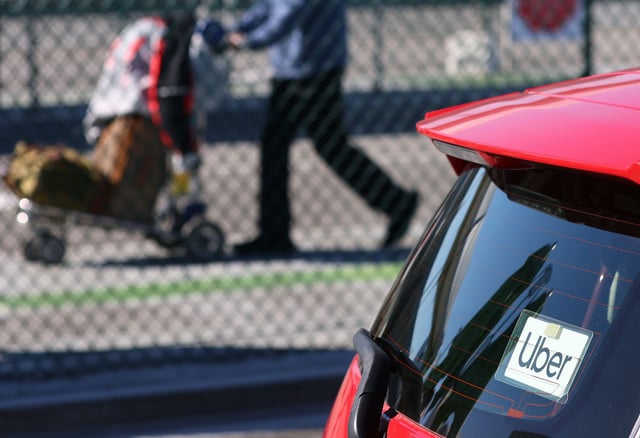 An Uber rideshare vehicle idles in a line to pick up passengers at Los Angeles International Airport (LAX) on February 8, 2023 in Los Angeles, California.