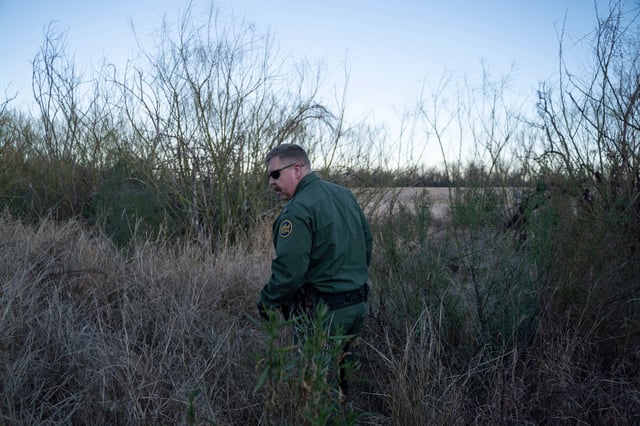 Border Patrol Presidio Station Agent in Charge Derek Boyle walks through brush along the US-Mexico Border on January 29, 2020 near Presidio, Texas. - Agents in the Big Bend Border Patrol Sector employ tracking techniques and spend a lot of time on foot and on horseback to pursue smugglers, and drug or human traffickers through the remote terrain of West Texas. Operating in remote and inhospitable terrain miles from anywhere, the green-clad Border Patrol agents are on the frontlines of a wave of Central American migrants heading into the US that has prompted a crackdown by President Donald Trump. (Photo by Paul Ratje / AFP) (Photo by PAUL RATJE/AFP via Getty Images)
