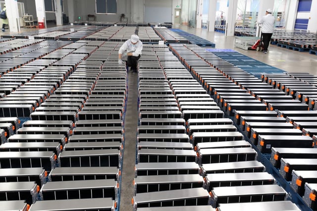 A worker with car batteries in a factory in China’s eastern Jiangsu province. File photo: TNS