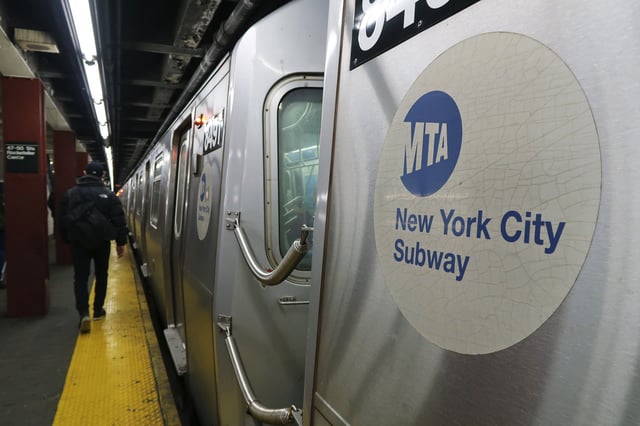 A subway train pulls into a station under Rockefeller Center in 2018 in New York City.