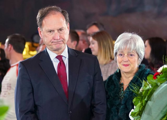 In this file photograph, Supreme Court Justice Samuel Alito Jr., left, and his wife Martha-Ann Alito, pay their respects at the casket of Reverend Billy Graham at the Rotunda of the U.S. Capitol Building in Washington, D.C., on February 28, 2018. An upside-down American flag, a symbol associated with Donald Trump's false claims of election fraud, was displayed outside of Alito's home days after Trump supporters stormed the U.S. Capitol, The New York Times reports. "It was briefly placed by Mrs. Alito in response to a neighbor's use of objectionable and personally insulting language on yard signs," Alito said in an emailed statement to the newspaper.