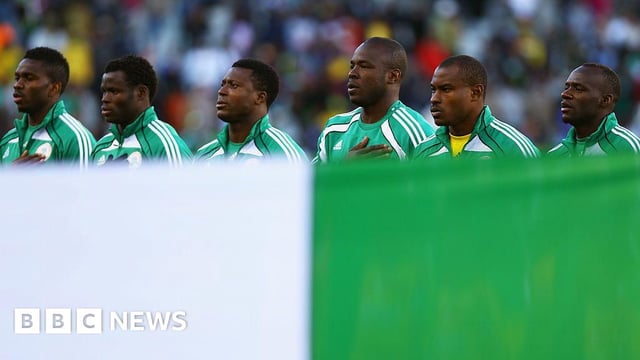 Nigeria players line up behind their flag for their national anthem during the 2010 FIFA World Cup South Africa