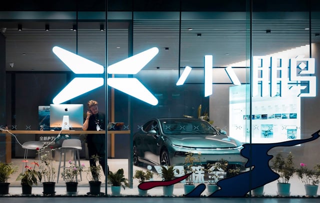 A man talks on the phone in a shop of Chinese electric vehicle manufacturer Xpeng, in Shanghai, China in September 2023. The European Commission on 13 September had launched an investigation aimed at assessing the feasibility of imposing punitive tariffs on Chinese electric vehicle (EV) imports. Photo: EPA-EFE