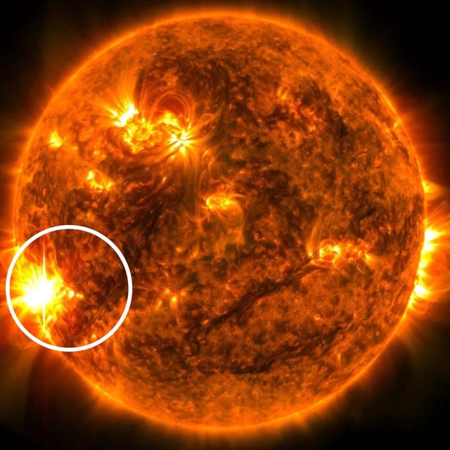 NASA’s Solar Dynamics Observatory of the sun releasing a solar flare on May 29, 2024. The area circled in white is the sunspot releasing the bright flare.