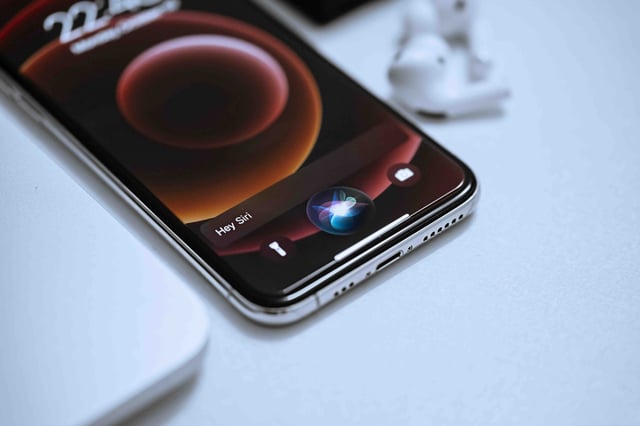 Apple Siri AI on an iPhone which is laid down on a desk