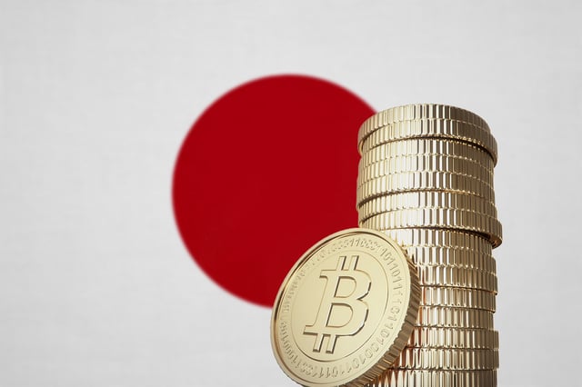 Bitcoin stack with a national flag in the background. (Credit: btgbtg/iStock/Getty Images)