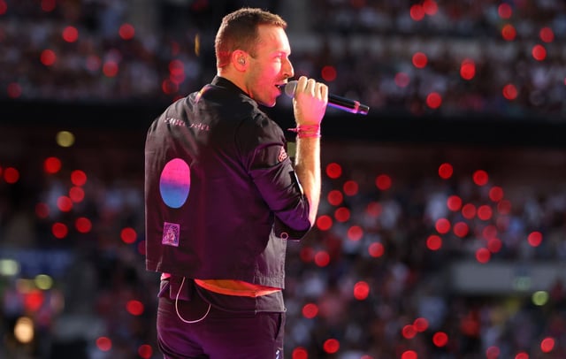 Coldplay performing on stage at Wembley Stadium, north London, during their 'Music of the Spheres' tour. CREDIT: Suzan Moore/PA Images via Getty Images