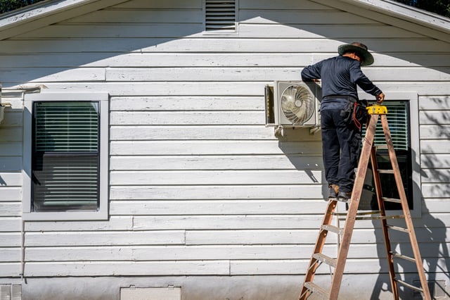 AC technician repairs an air conditioning unit on July 10, 2023 in Austin, Texas.