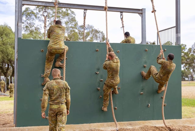 Students climb a wall at the Recruit Training Unit course in Australia. Photo: Australian Defense Force via AP