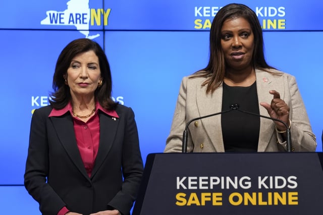 New York Gov. Kathy Hochul, left, listens as Attorney General Letitia James speaks during a news conference in New York, Oct. 11, 2023. New York lawmakers on Tuesday, June 4, said they were finalizing legislation that would allow parents to block their children from getting social media posts curated by a platform's algorithm, a move to rein in feeds that critics argue keep young users glued to their screens. Hochul and James have been advocating for the regulations since October, facing strong pushback from the tech industry. (AP Photo/Seth Wenig, File)