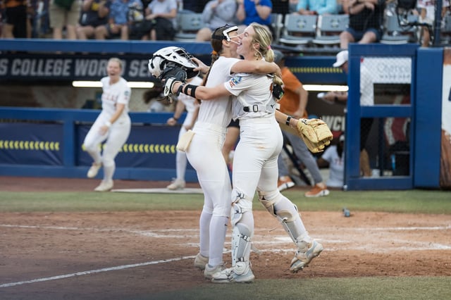 Texas pitcher Teagan Kavan, left, hugs catcher Reese Atwood after the Longhorns defeated Stanford 1-0 Monday night in the semifinals to advance to the Women's College World Series championship series at Devon Park in Oklahoma City. Kavan, a freshman, threw a one-hit compete game.